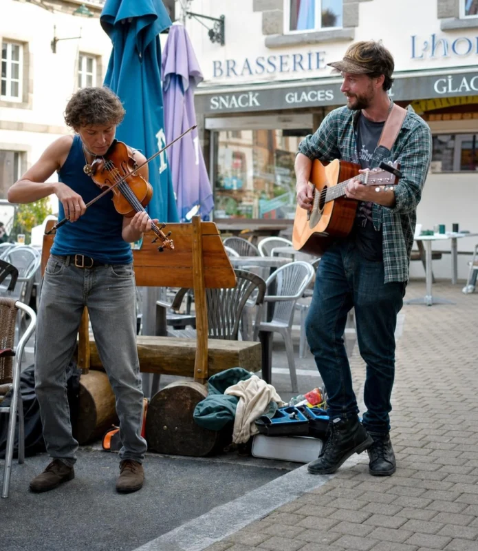 Two musicians busking in the street.