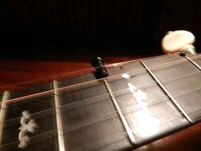 Banjo capo made out of a guitar bridge pin