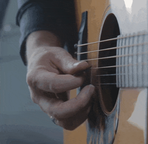 Animated GIF showing the pick pushing through one string to land on the next one.