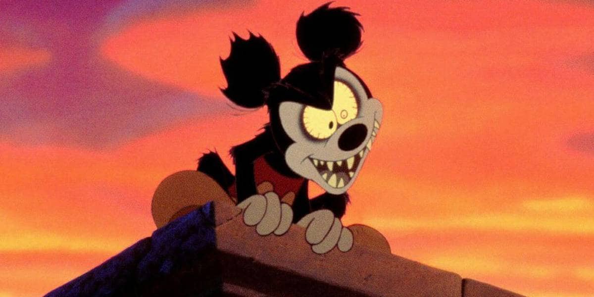 A horific, zombie version of Mickey Mouse standing on the roof of some building.