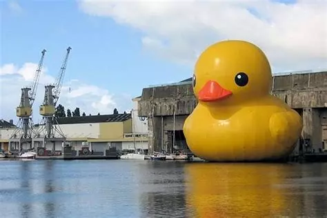 A giant inflatable duck floating in front of an old nazi submarine base. I'm not making that up, I swear