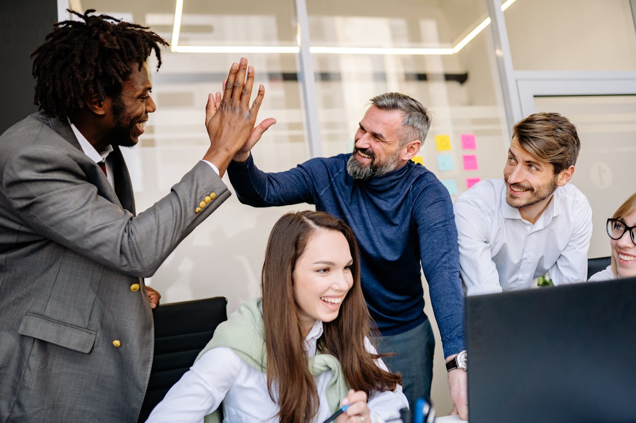 Good job everyone! Stock photo. People celebrating in an office.