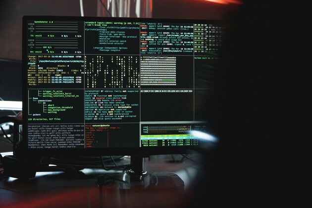 A computer screen split into many small panels, each displaying random compurery nonsense.